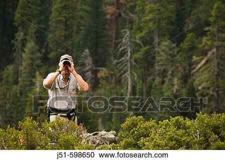 CALIFORNIA South Lake Tahoe Male day hiker use binoculars from overlook point View Large Photo Image Stock Image - CALIFORNIA South Lake Tahoe Male day hiker use binoculars from overlook point. Fotosearch