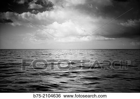 Calm sea landscape with clouds in the sky in black and white. Mediterranean sea, Balearic islands, Spain. View Large Photo Image Stock Photograph - Calm sea landscape with clouds in the sky in black and white. Mediterranean sea, Balearic islands, Spain.. Fotosearch