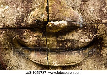 Cambodia, Angkor Thom, Bayon Massive stone faces watch your every move at Bayon, a well-known and richly decorated Khmer temple at Angkor in Cambodia View Large Photo Image Stock Photo - Cambodia, Angkor Thom, Bayon Massive stone faces watch your every move at Bayon, a well-known and richly decorated Khmer temple at Angkor in Cambodia. Fotosearch