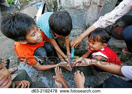 CAMBODIA. Children washing ands before eating school meal. View Large Photo Image Stock Photo - CAMBODIA. Children washing ands before eating school meal.. Fotosearch