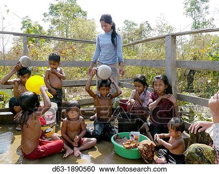 Stock Image - CAMBODIA. Projects of DPA in Stung Treng, supported by SCIAF. Mothers and children washing at a well in Kamphun village. Fotosearch