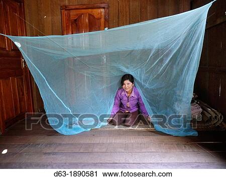 Stock Image - CAMBODIA. Projects of DPA in Stung Treng, supported by SCIAF. Katot village. Case study of Mrs Thong Leung, 35, who has a fish pond. Mosquito net. Fotosearch