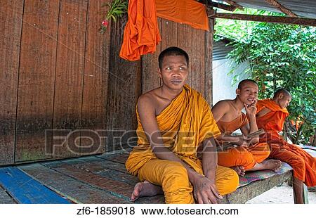Cambodia, Siem Reap, Young monks in front of home View Large Photo Image Stock Photo - Cambodia, Siem Reap, Young monks in front of home. Fotosearch