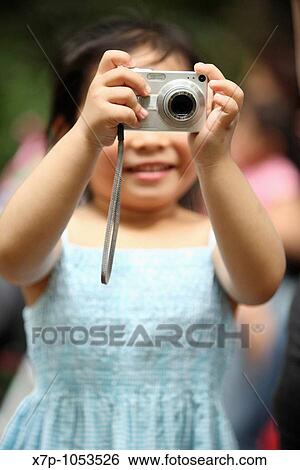 Camera held by young girl View Large Photo Image Stock Photograph - Camera held by young girl. Fotosearch