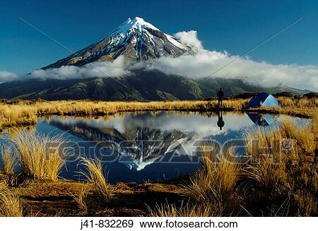 Camping beside tarn reflecting Mt Egmont / Taranaki on the Pouakai Range Egmont National Park New Zealand View Large Photo Image Stock Photo - Camping beside tarn reflecting Mt Egmont / Taranaki on the Pouakai Range Egmont National Park New Zealand. Fotosearch