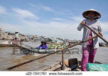 Can Tho (Vietnam): a woman on a canoe at the Cat Rang floating market View Large Photo Image Stock Image - Can Tho (Vietnam): a woman on a canoe at the Cat Rang floating market. Fotosearch
