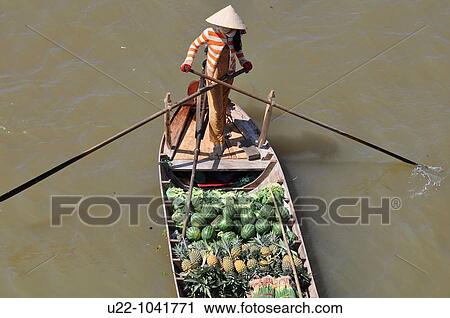 Can Tho (Vietnam): a woman selling fruit at the Cat Rang floating market View Large Photo Image Stock Image - Can Tho (Vietnam): a woman selling fruit at the Cat Rang floating market. Fotosearch