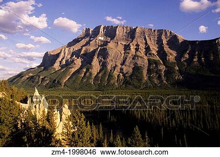 Stock Photograph - CANADA, ALBERTA, ROCKY MOUNTAINS, BANFF NATIONAL PARK, HOODOOS ROCK FORMATION WITH RUNDLE MT.. Fotosearch
