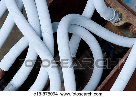 Picture - Canada, BC, Sicamous. Confusion of hydraulic hoses on old saw mill equipment.. Fotosearch