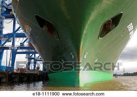 Canada, BC, Surrey. Bow of large green freighter docked at the Surrey Fraser Port container terminal. On the lower Fraser River, near Vancouver. View Large Photo Image Stock Image - Canada, BC, Surrey. Bow of large green freighter docked at the Surrey Fraser Port container terminal. On the lower Fraser River, near Vancouver.. Fotosearch