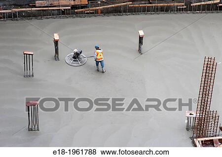 Canada, BC, Vancouver. Construction worker leveling concrete on floor our new building. View Large Photo Image Stock Photo - Canada, BC, Vancouver. Construction worker leveling concrete on floor our new building.. Fotosearch
