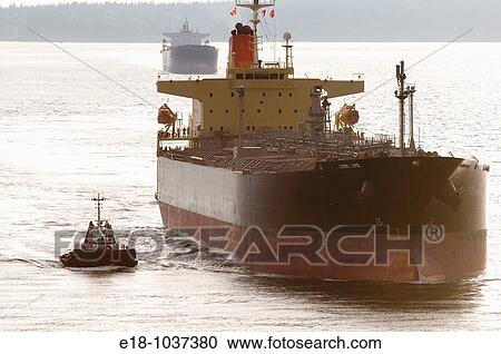 Canada, BC, Vancouver Freighter is escorted in the Burrard Inlet by harbour tugs. View Large Photo Image Stock Image - Canada, BC, Vancouver Freighter is escorted in the Burrard Inlet by harbour tugs.. Fotosearch