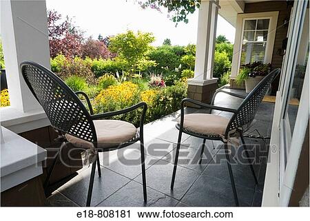 Canada, BC, Vancouver. Metal garden chairs on porch looking out at residential garden View Large Photo Image Stock Image - Canada, BC, Vancouver. Metal garden chairs on porch looking out at residential garden. Fotosearch