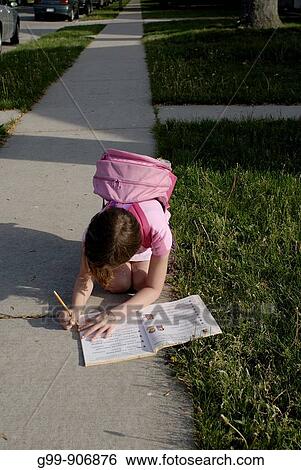 Canada, Ontario, Windsor. An eight year old girl with a pink knapsack writes in a notebook on a sidewalk. View Large Photo Image Stock Photograph - Canada, Ontario, Windsor. An eight year old girl with a pink knapsack writes in a notebook on a sidewalk.. Fotosearch