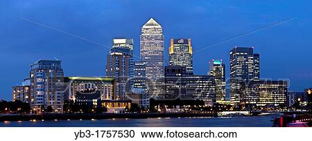 Stock Image - Canary Wharf Financial District At Night, Viewed Across The River Thames, London, England. Fotosearch