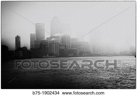 Canary Wharf, seen from the river Thames with fog, London, England, UK View Large Photo Image Picture - Canary Wharf, seen from the river Thames with fog, London, England, UK. Fotosearch