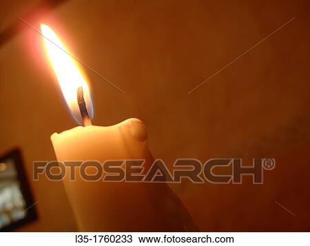 Stock Image - Candle in a bar, Goslar, Lower Saxony, Germany. Fotosearch