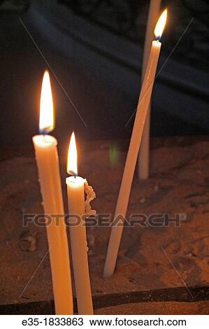 Candles lit to remember the dead in a church in France View Large Photo Image Stock Image - Candles lit to remember the dead in a church in France. Fotosearch