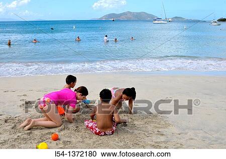 Stock Image - Cane Garden Bay Beach Tortola BVI Caribbean Playing in Sand. Fotosearch