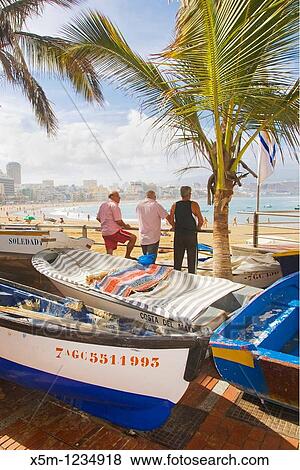 Stock Photo - Canteras beach on a sunny day before a storm with all the fish boats up on the promenade. Fotosearch