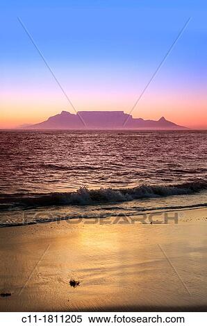 Stock Photography - cape town from bloubergstrand at dusk sunset showing lights ocean and beach. Fotosearch