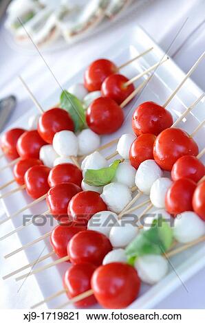 Stock Image - Caprese, mozzarella, tomato and basil. Fotosearch