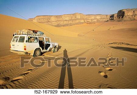 Car at Tadrart Akakus region. Fezzan. Sahara desert. Libya View Large Photo Image Stock Photo - Car at Tadrart Akakus region. Fezzan. Sahara desert. Libya. Fotosearch
