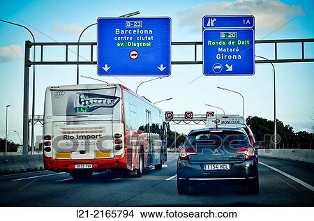 Car, bus on the road, passing under signs. Entrance to the city of Barcelona by the Diagonal Avenue. Barcelona, Catalonia, Spain. View Large Photo Image Picture - Car, bus on the road, passing under signs. Entrance to the city of Barcelona by the Diagonal Avenue. Barcelona, Catalonia, Spain.. Fotosearch