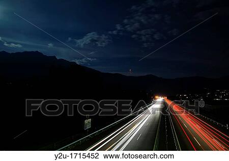 Car lights on a highway at night with moon light View Large Photo Image Stock Image - Car lights on a highway at night with moon light. Fotosearch