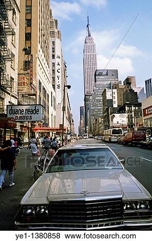 Car parked in a downtown street with the Empire State Building in the background, Manhattan, New York, USA View Large Photo Image Stock Photo - Car parked in a downtown street with the Empire State Building in the background, Manhattan, New York, USA. Fotosearch