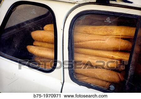 Stock Image - Car Renault 4L, filled with baguettes.. Fotosearch