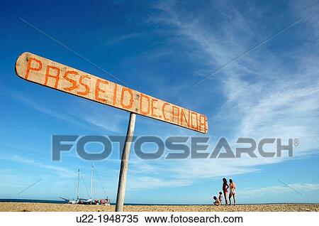 Stock Photography - Cara? va, Bahia, Brazil, sign offering canoe tours at the beach. Fotosearch