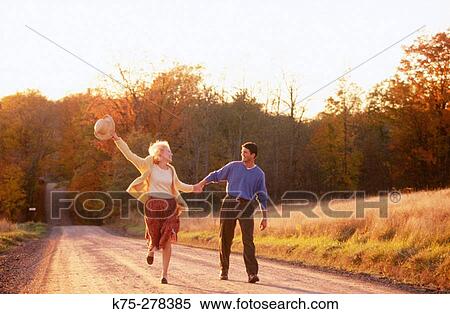 carefree couple on country road View Large Photo Image Stock Photography - carefree couple on country road. Fotosearch