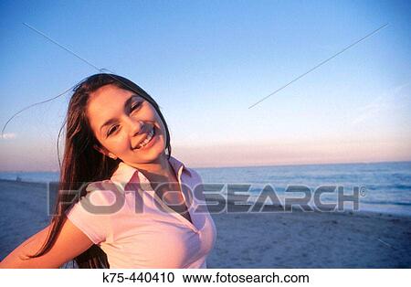 Stock Image - Carefree teen at beach. Fotosearch