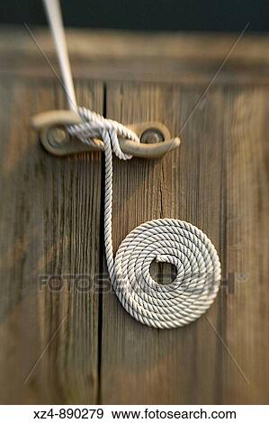carefully cleated line from boat on dock is neatly presented View Large Photo Image Stock Photo - carefully cleated line from boat on dock is neatly presented. Fotosearch