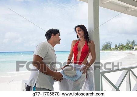 Stock Image - Caribbean Barbados Couple on a deserted beach.. Fotosearch
