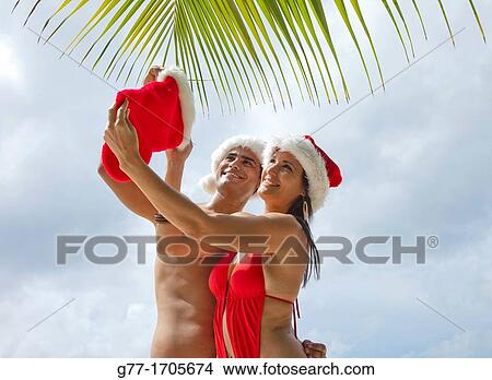 Caribbean Barbados Couple with Santa hats. View Large Photo Image Picture - Caribbean Barbados Couple with Santa hats.. Fotosearch