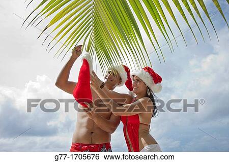 Caribbean Barbados Couple with Santa hats. View Large Photo Image Stock Photograph - Caribbean Barbados Couple with Santa hats.. Fotosearch