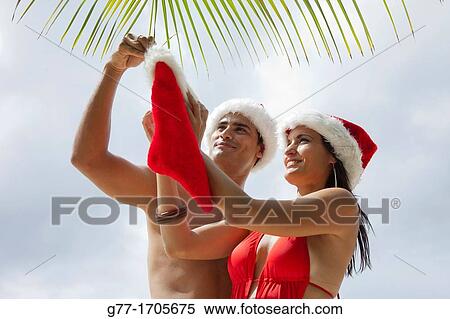 Caribbean Barbados Couple with Santa hats. View Large Photo Image Stock Photography - Caribbean Barbados Couple with Santa hats.. Fotosearch
