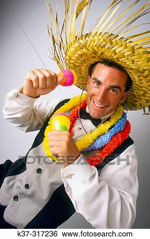 Caribbean style entertainer wearing palm frond hat and leis around his neck View Large Photo Image Stock Photograph - Caribbean style entertainer wearing palm frond hat and leis around his neck. Fotosearch