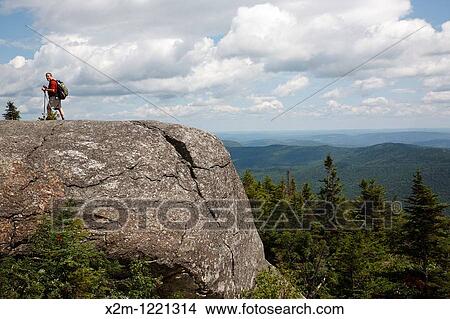 Picture - Caribou - Speckled Mountain Wilderness - A hiker explores the exposed summit of Caribou Mountain in the White Mountain National Forest of Maine. Fotosearch