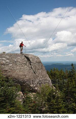 Caribou - Speckled Mountain Wilderness - A hiker explores the exposed summit of Caribou Mountain in the White Mountain National Forest of Maine View Large Photo Image Stock Image - Caribou - Speckled Mountain Wilderness - A hiker explores the exposed summit of Caribou Mountain in the White Mountain National Forest of Maine. Fotosearch