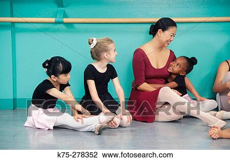Caring teacher with her ballet class View Large Photo Image Stock Image - Caring teacher with her ballet class. Fotosearch