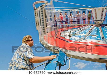 Carnival worker operating a ride. View Large Photo Image Stock Image - Carnival worker operating a ride.. Fotosearch