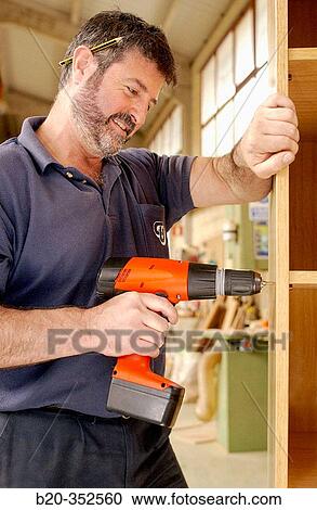 Carpenter making wooden furniture with screwing machine View Large Photo Image Stock Image - Carpenter making wooden furniture with screwing machine. Fotosearch