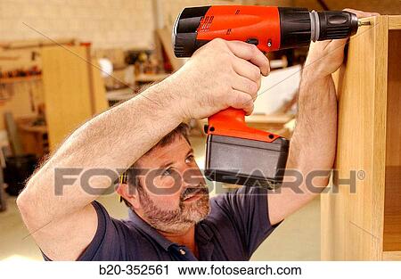 Carpenter making wooden furniture with screwing machine View Large Photo Image Stock Image - Carpenter making wooden furniture with screwing machine. Fotosearch