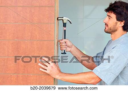 Carpenter with hammer with carbon fiber handle. Construction of residential building. Donostia. San Sebastian. Gipuzkoa. Basque Country. Spain. View Large Photo Image Stock Photo - Carpenter with hammer with carbon fiber handle. Construction of residential building. Donostia. San Sebastian. Gipuzkoa. Basque Country. Spain.. Fotosearch