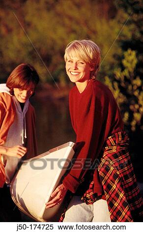 Stock Photography - Carrying canoe. Fotosearch
