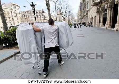 Carrying clothes, Passeig de Gracia avenue, Barcelona, Catalonia, Spain View Large Photo Image Stock Photo - Carrying clothes, Passeig de Gracia avenue, Barcelona, Catalonia, Spain. Fotosearch
