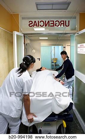 Stock Photo - Carrying patient on couch, emergency. Hospital Policlinica Gipuzkoa, San Sebastian, Donostia, Euskadi, Spain. Fotosearch